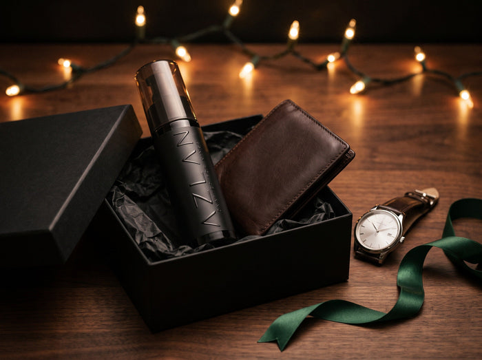 AZLAN bottle with a leather wallet and gift box on a wooden table under warm string lights